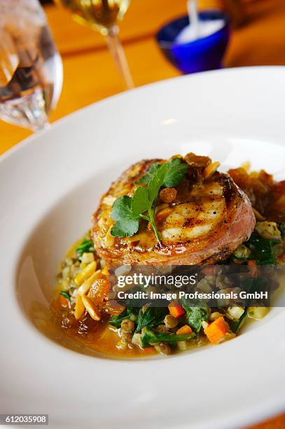 prosciutto wrapped swordfish over spinach and lentil salad - prosciutto wrapped stock pictures, royalty-free photos & images