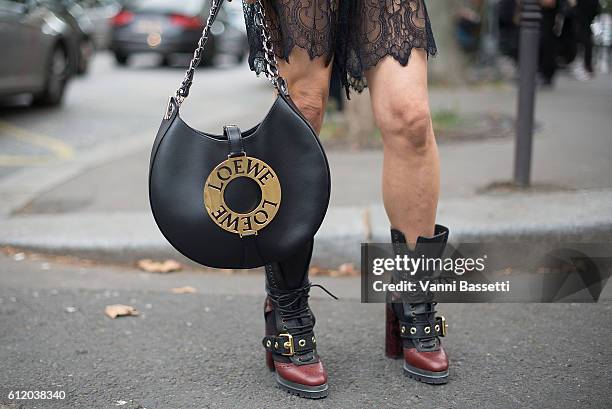 Guest poses wearing Burberry shoes and Loewe Joyce bag after the Valentino show at the Hotel Salomon de Rothschild during Paris Fashion Week...