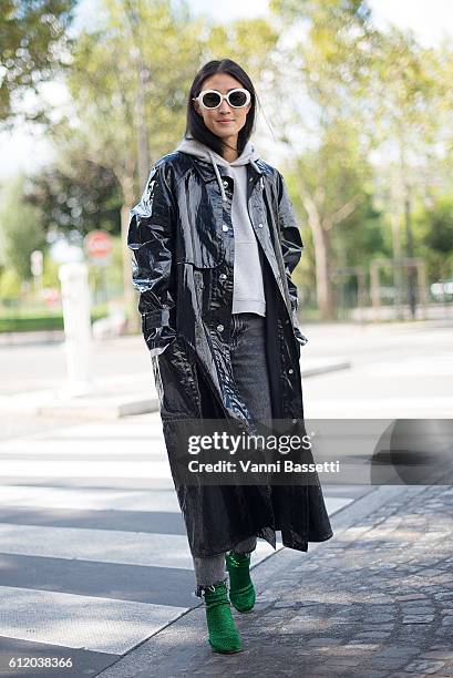 Justine Lee poses wearing an Isabel Marant coat and Vetements shoes after the Celine show at the Tennis Club de Paris during Paris Fashion Week...