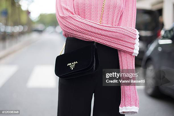 Guest poses wearing Celine jumper and pants and Prada bag after the Valentino show at the Hotel Salomon de Rothschild during Paris Fashion Week...