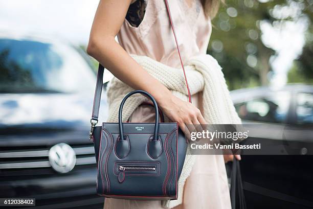 Model poses with a Celine bag after the Celine show at the Tennis Club de Paris during Paris Fashion Week Womenswear SS17 on October 2, 2016 in...