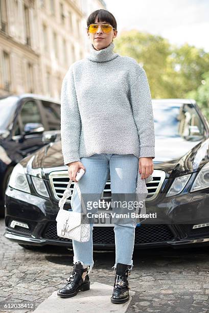 Guest poses wearing a Balenciaga top and a JW Anderson bag after the Valentino show at the Hotel Salomon de Rothschild during Paris Fashion Week...