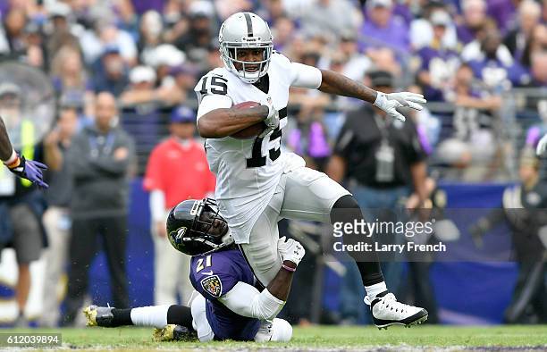 Lardarius Webb of the Baltimore Ravens tackles Michael Crabtree of the Oakland Raiders in the second quarter at M&T Bank Stadium on October 2, 2016...