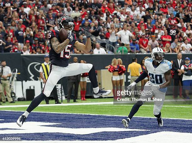 Will Fuller of the Houston Texans catches a pass for a touchdown defended by Perrish Cox of the Tennessee Titans in the first quarter of the NFL game...