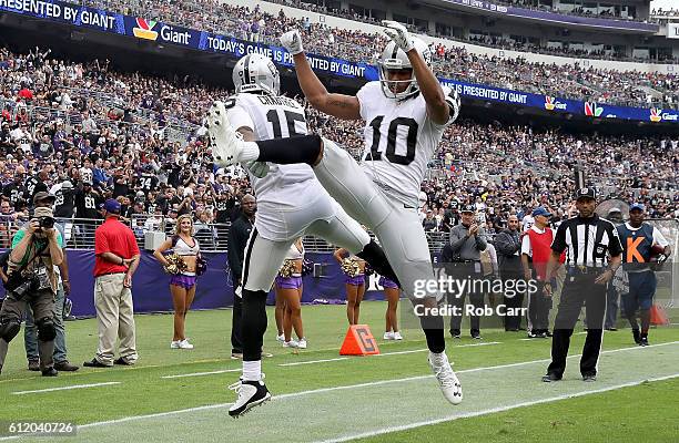 Michael Crabtree and Seth Roberts of the Oakland Raiders celebrate after Crabtree scored a touchdown in the second quarter against the Baltimore...