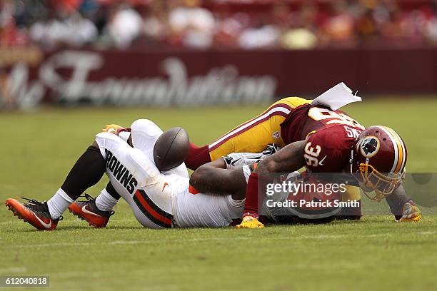 Running back George Atkinson of the Cleveland Browns is tackled by defensive back Su'a Cravens of the Washington Redskins in the second quarter at...