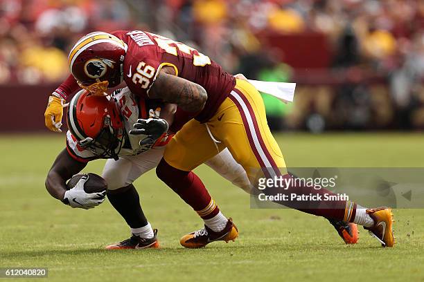 Running back George Atkinson of the Cleveland Browns is tackled by defensive back Su'a Cravens of the Washington Redskins in the second quarter at...