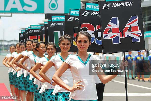 Grid girls pose for photograph at the grid before the start of the Formula 1 Petronas Malaysia Grand Prix held at Sepang International Circuit in...