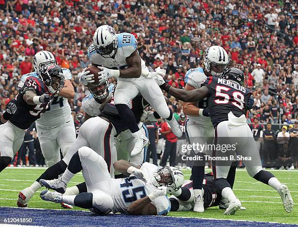 DeMarco Murray of the Tennessee Titans leaps over the Houston Texans defensive line for a touchdown in the second quarter during the NFL game between...