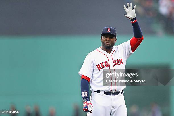 David Ortiz of the Boston Red Sox waves to fans during the pregame ceremony to honor his retirement before his last regular season home game at...