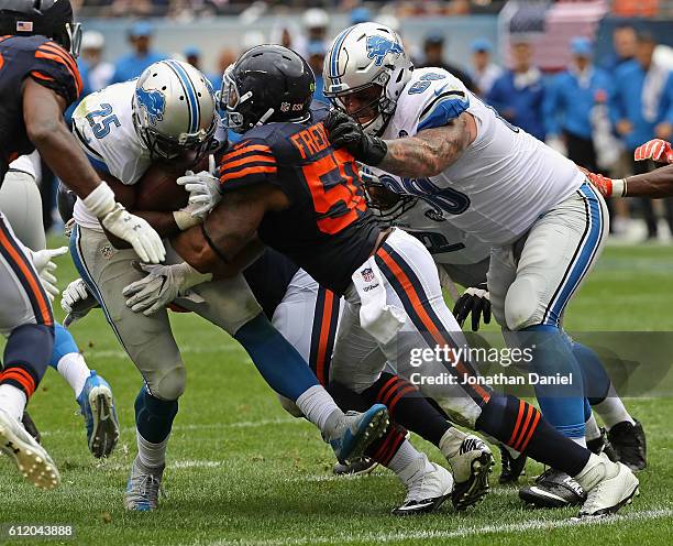 Theo Riddick of the Detroit Lions is stopped short of the goal on third down by Jerrell Freeman of the Chicago Bears at Soldier Field on October 2,...