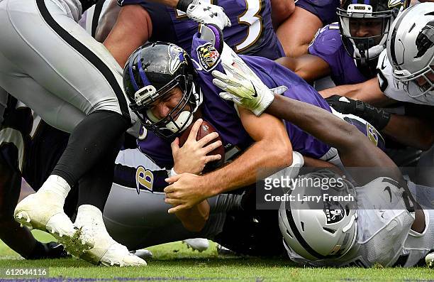 Joe Flacco of the Baltimore Ravens scores a touchdown in the third quarter against the Oakland Raiders at M&T Bank Stadium on October 2, 2016 in...