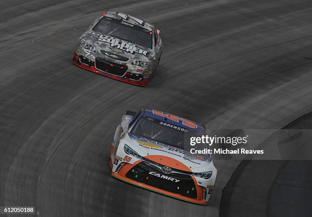 Regan Smith, driver of the Citizen Soldier Chevrolet, races Reed Sorenson, driver of the Vydox Plus Toyota, during the NASCAR Sprint Cup Series...