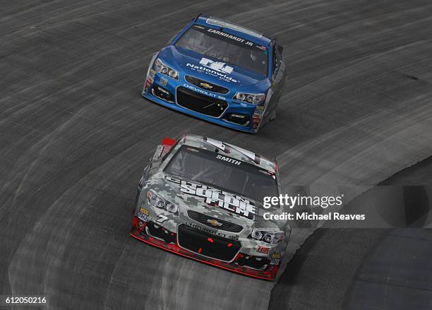 Regan Smith, driver of the Citizen Soldier Chevrolet, races Jeff Gordon, driver of the Nationwide Chevrolet, during the NASCAR Sprint Cup Series...