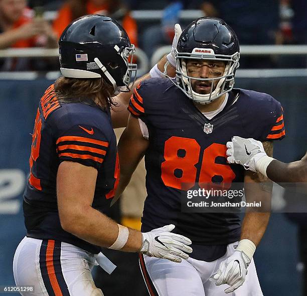 Zach Miller of the Chicago Bears is congratulated by Logan Paulsen after catching a touchdown pass in the third quarter against the Detroit Lions at...