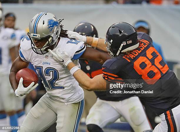 Andre Roberts of the Detroit Lions shakes off a tackle attempt by Logan Paulsen of the Chicago Bears to return a punt for a touchdown in the 4th...