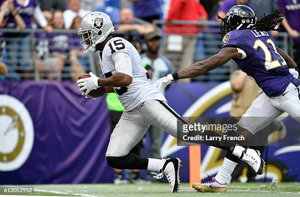 Michael Crabtree of the Oakland Raiders scores a touchdown past Kendrick Lewis of the Baltimore Ravens in the fourth quarter at M&T Bank Stadium on...