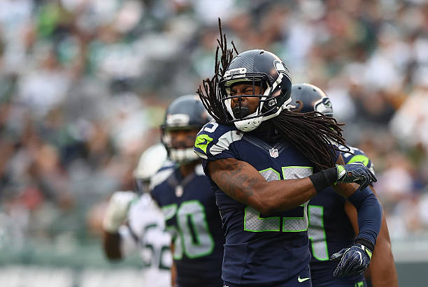 Richard Sherman of the Seattle Seahawks celebrates an interception in the third quarter against the New York Jets at MetLife Stadium on October 2,...