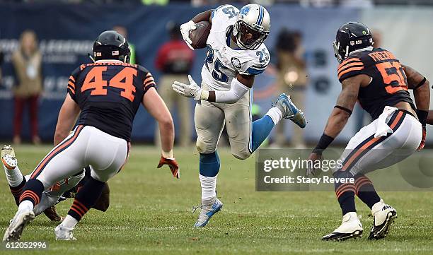 Theo Riddick of the Detroit Lions is pursued by Nick Kwiatkoski and Jerrell Freeman of the Chicago Bears during the second half of a game at Soldier...