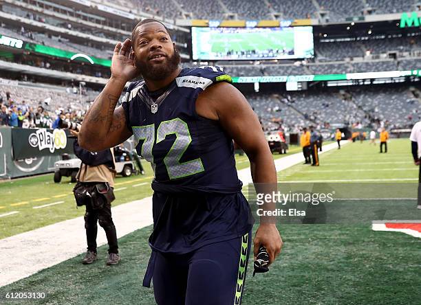 Michael Bennett of the Seattle Seahawks listens to the screaming fans as he exits the field after the game against the New York Jets at MetLife...