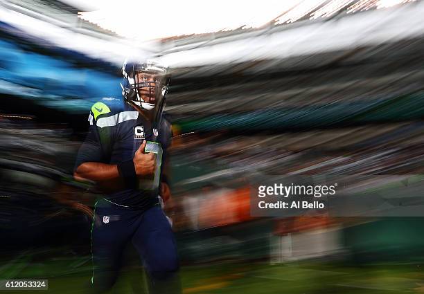 Russell Wilson of the Seattle Seahawks runs onto the field before the game against the New York Jets at MetLife Stadium on October 2, 2016 in East...