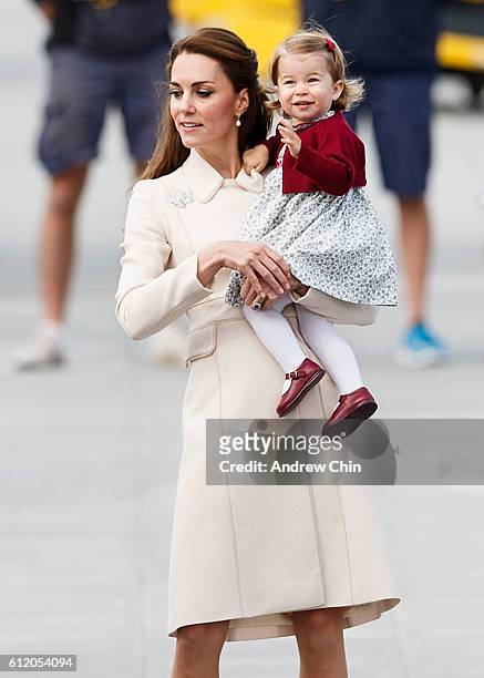 Catherine, Duchess of Cambridge and Princess Charlotte wave as they leave from Victoria Harbour to board a seaplane on the final day of their Royal...
