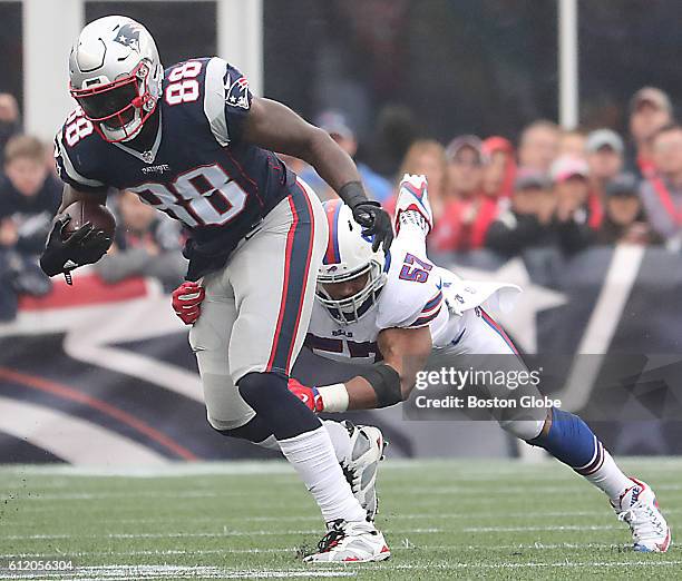 New England Patriots tight end Martellus Bennett escapes Buffalo Bills linebacker Lorenzo Alexander after a reception during third quarter action at...