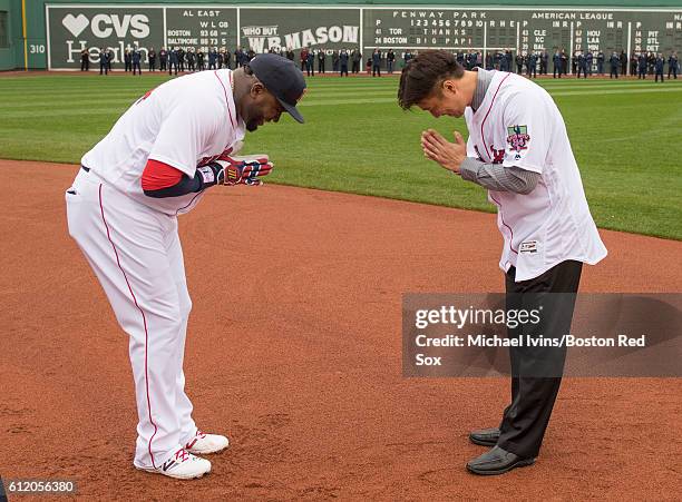 David Ortiz of the Boston Red Sox bows to former teammate Hideki Okajima during a ceremony honoring him before his final regular season game on...