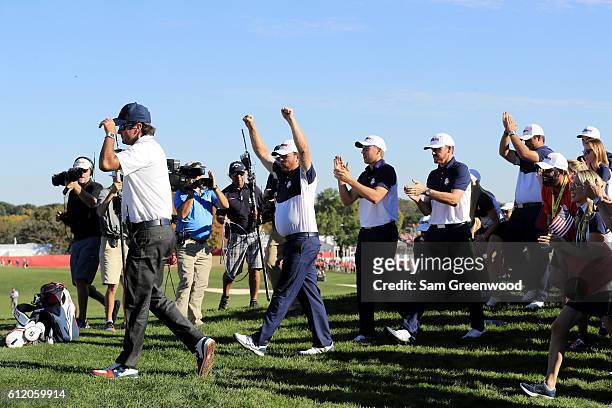 Vice-captain Bubba Watson, J.B. Holmes, Jordan Spieth and Jimmy Walker of the United States celebrate on the 18th green after winning the Ryder Cup...