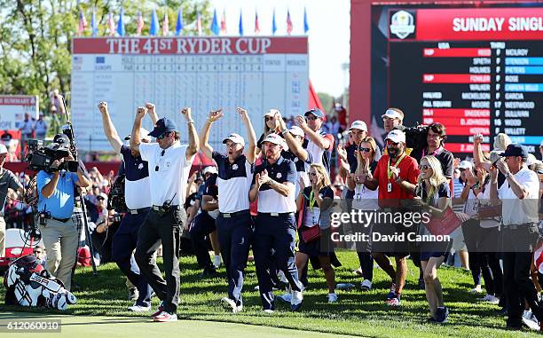 Vice-captain Bubba Watson, J.B. Holmes, Jordan Spieth and Jimmy Walker of the United States celebrate on the 18th green after winning the Ryder Cup...
