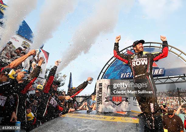 Martin Truex Jr., driver of the Furniture Row/Denver Mattress Toyota, celebrates in Victory Lane after winning the NASCAR Sprint Cup Series Citizen...