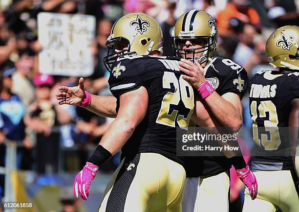 John Kuhn is congratulated by Drew Brees of the New Orleans Saints after a touchdown against the San Diego Chargers at Qualcomm Stadium on October 2,...