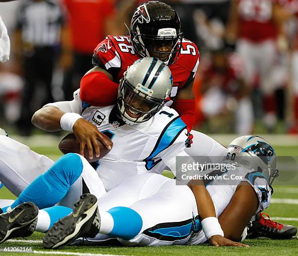 Cam Newton of the Carolina Panthers is hit by Sean Weatherspoon of the Atlanta Falcons after pushing for a first down at Georgia Dome on October 2,...