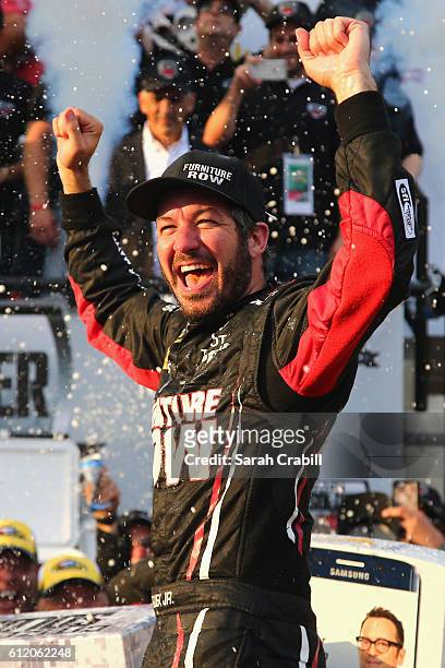 Martin Truex Jr., driver of the Furniture Row/Denver Mattress Toyota, celebrates in Victory Lane after winning the NASCAR Sprint Cup Series Citizen...