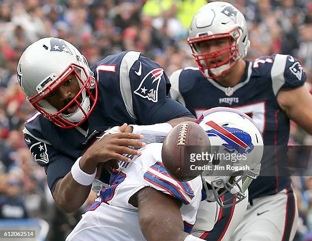 Jacoby Brissett of the New England Patriots fumbles the ball as he is hit by Zach Brown Buffalo Bills in the first half at Gillette Stadium on...