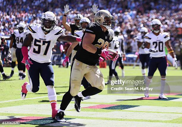 Jatavis Brown of the San Diego Chargers pursues John Kuhn of the New Orleans Saints as Kuhn scores a touchdown against the San Diego Chargers in the...