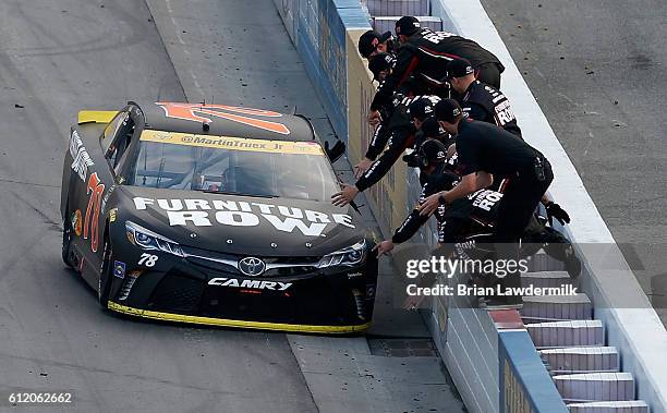 Martin Truex Jr., driver of the Furniture Row/Denver Mattress Toyota, celebrates with his crew after winning the NASCAR Sprint Cup Series Citizen...