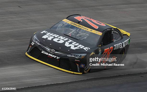 Martin Truex Jr., driver of the Furniture Row/Denver Mattress Toyota, races during the NASCAR Sprint Cup Series Citizen Solider 400 at Dover...