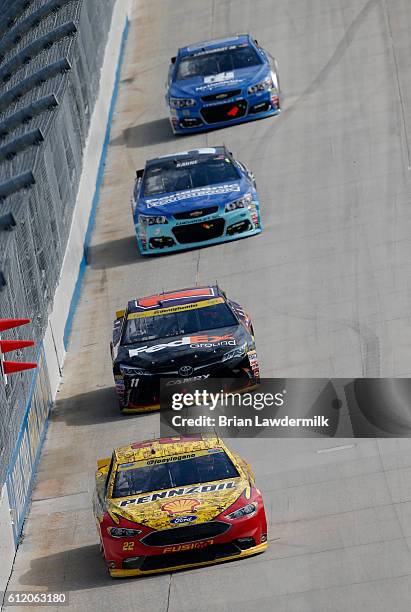 Joey Logano, driver of the Shell Pennzoil Ford, leads a pack of cars during the NASCAR Sprint Cup Series Citizen Solider 400 at Dover International...