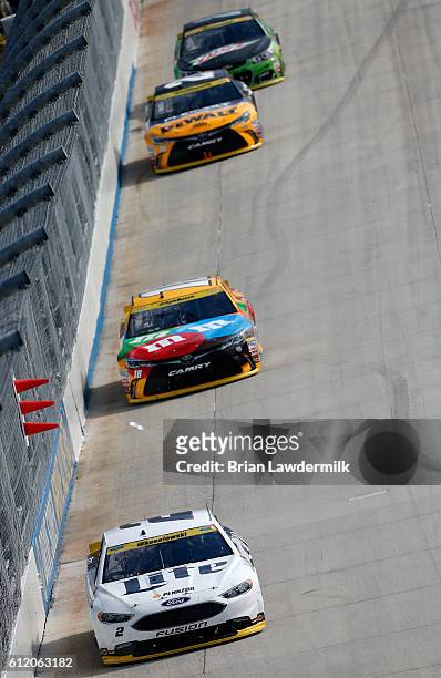 Brad Keselowski, driver of the Miller Lite Ford, leads a pack of cars during the NASCAR Sprint Cup Series Citizen Solider 400 at Dover International...