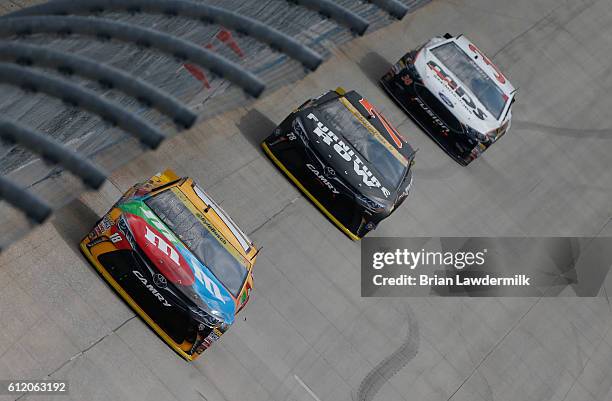 Kyle Busch, driver of the M&M's Core Toyota, leads a pack of cars during the NASCAR Sprint Cup Series Citizen Solider 400 at Dover International...