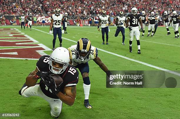 Wide receiver Michael Floyd of the Arizona Cardinals catches a 5 yard touchdown reception in front of cornerback Troy Hill of the Los Angeles Rams...