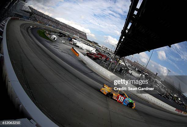 Kyle Busch, driver of the M&M's Core Toyota, races during the NASCAR Sprint Cup Series Citizen Solider 400 at Dover International Speedway on October...