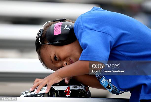 Young fan plays with a toy replica of the Jimmy John's Chevrolet during the NASCAR Sprint Cup Series Citizen Solider 400 at Dover International...