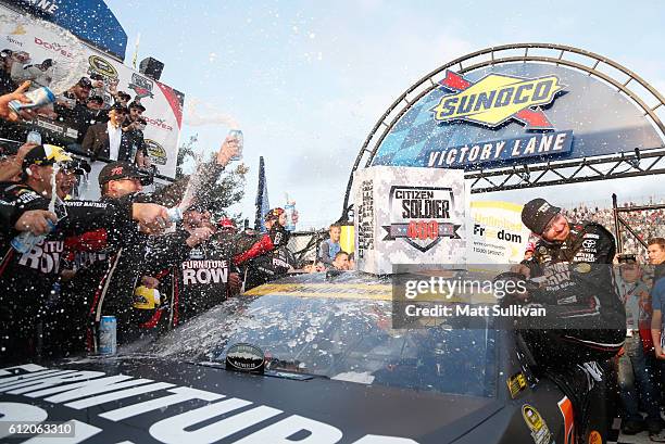 Martin Truex Jr., driver of the Furniture Row/Denver Mattress Toyota, celebrates in Victory Lane after winning the NASCAR Sprint Cup Series Citizen...