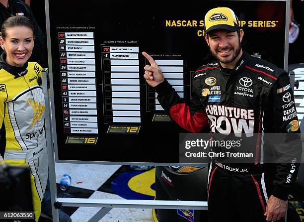 Martin Truex Jr., driver of the Furniture Row/Denver Mattress Toyota, poses with the Sprint Cup Chase grid board after winning the NASCAR Sprint Cup...