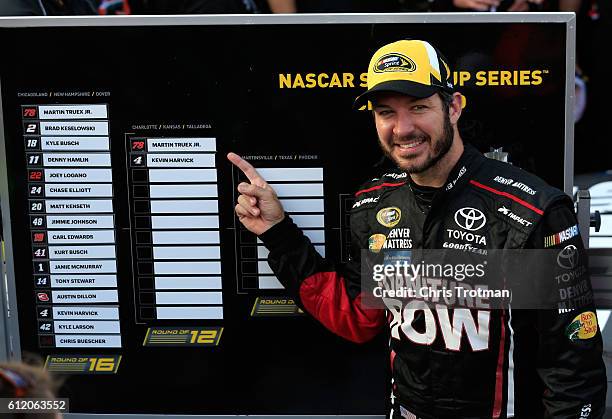 Martin Truex Jr., driver of the Furniture Row/Denver Mattress Toyota, poses with the Sprint Cup Chase grid board after winning the NASCAR Sprint Cup...