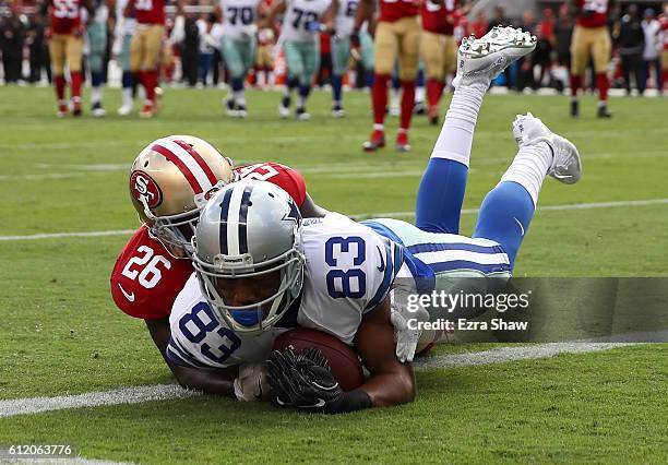 Terrance Williams of the Dallas Cowboys makes a leaping catch for a touchdown against Tramaine Brock of the San Francisco 49ers during the second...