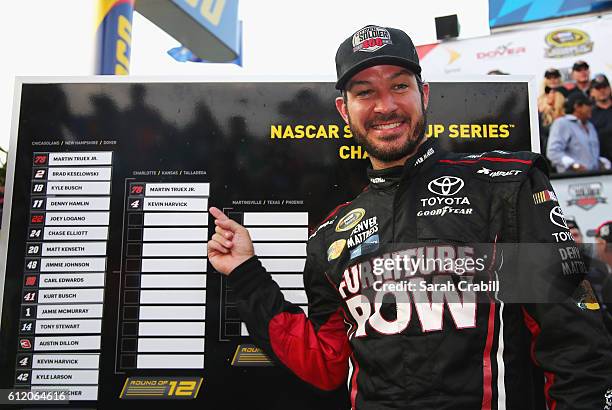 Martin Truex Jr., driver of the Furniture Row/Denver Mattress Toyota, poses with the Sprint Cup Chase grid board after winning the NASCAR Sprint Cup...