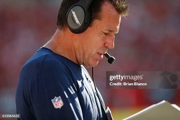 Head coach Gary Kubiak of the Denver Broncos looks over his playbook during the second quarter of an NFL game against the Tampa Bay Buccaneers on...